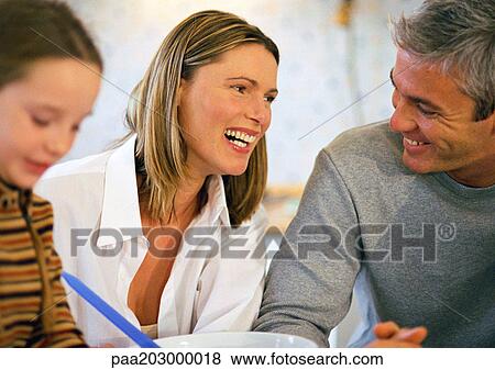 Family sitting together laughing, close up. View Large Photo Image Stock Photo - Family sitting together laughing, close up.. Fotosearch