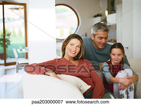 Stock Photo - Family sitting together, portrait.. Fotosearch