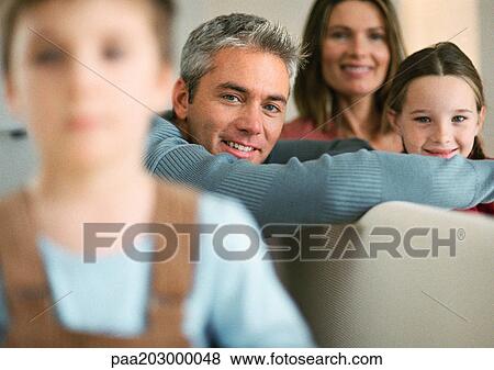 Family, young boy blurred in foreground, portrait. View Large Photo Image Stock Photo - Family, young boy blurred in foreground, portrait.. Fotosearch