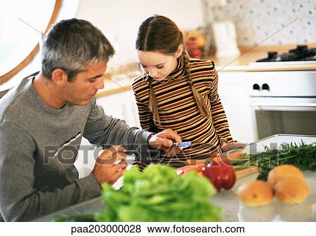 Father and daughter working together in kitchen. View Large Photo Image Stock Photo - Father and daughter working together in kitchen.. Fotosearch