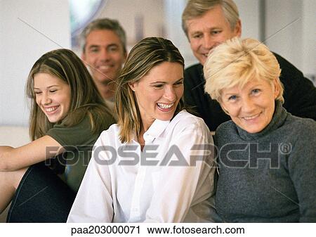 Stock Image - Five people grouped together, smiling, close-up, portrait.. Fotosearch