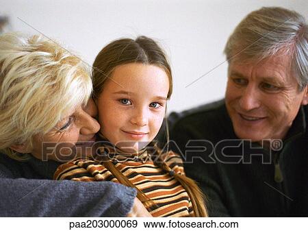 Stock Photo - Grandparents and granddaughter, portrait.. Fotosearch