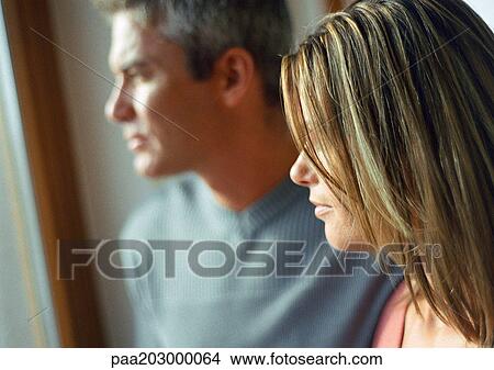 Man and woman, side view, head and shoulders, natural light on faces, close-up. View Large Photo Image Picture - Man and woman, side view, head and shoulders, natural light on faces, close-up.. Fotosearch