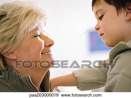 Senior woman and little boy and facing each other, side view, close up. View Large Photo Image Stock Photo - Senior woman and little boy and facing each other, side view, close up.. Fotosearch