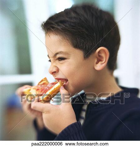 Stock Photograph - Boy eating slice of bread and jam, portrait. Fotosearch