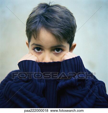 Boy holding sweater collar over mouth, portrait View Large Photo Image Stock Photo - Boy holding sweater collar over mouth, portrait. Fotosearch