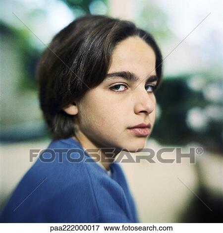 Stock Photo - Boy looking at camera, portrait. Fotosearch