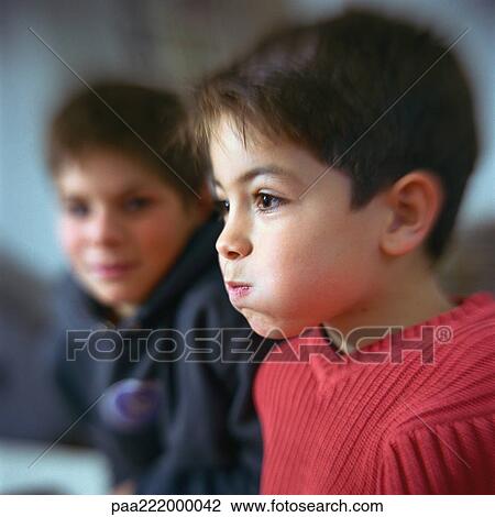 Boy puffing cheeks out, second boy looking at him in background View Large Photo Image Stock Image - Boy puffing cheeks out, second boy looking at him in background. Fotosearch