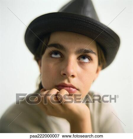 Stock Photo - Boy wearing hat, looking up, portrait. Fotosearch