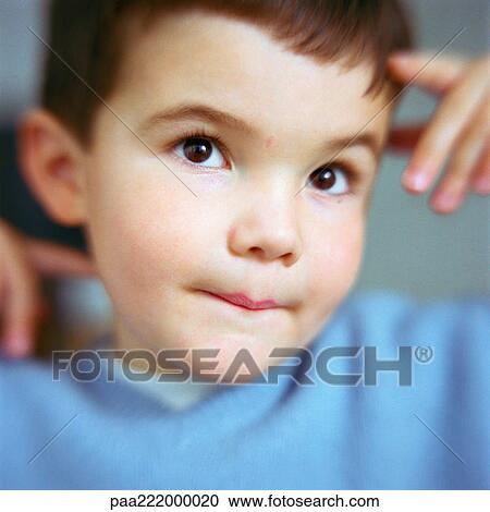 Boy with hands by face looking up, close-up View Large Photo Image Stock Image - Boy with hands by face looking up, close-up. Fotosearch