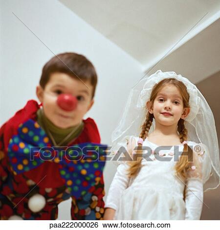 Stock Photograph - Girl and boy in costumes, low angle view. Fotosearch