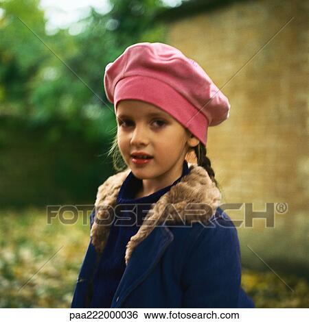Girl outside wearing hat and coat, looking at camera View Large Photo Image Stock Photograph - Girl outside wearing hat and coat, looking at camera. Fotosearch