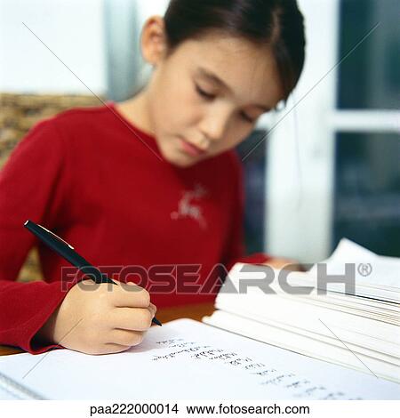 Girl sitting at table, writing View Large Photo Image Picture - Girl sitting at table, writing. Fotosearch