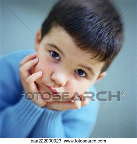 Stock Image - Little boy pouting, portrait. Fotosearch