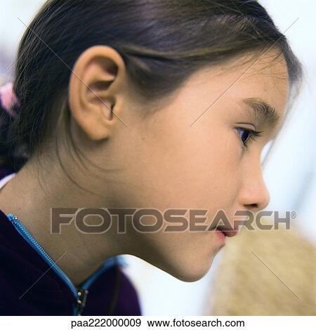 Stock Photo - Little girl, side view, close-up. Fotosearch