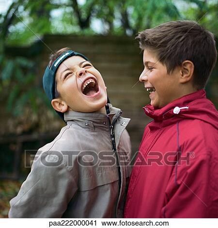 Two boys laughing outside View Large Photo Image Stock Image - Two boys laughing outside. Fotosearch