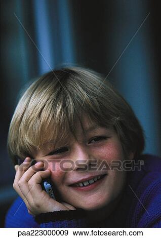 Young boy on phone, smiling, close up. View Large Photo Image Stock Photo - Young boy on phone, smiling, close up.. Fotosearch