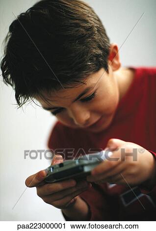 Young boy playing video game, close up. View Large Photo Image Stock Image - Young boy playing video game, close up.. Fotosearch