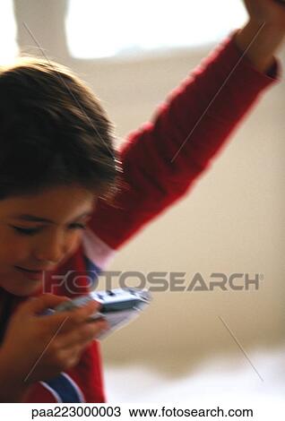Young boy playing video game, close up, blurred. View Large Photo Image Stock Image - Young boy playing video game, close up, blurred.. Fotosearch
