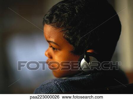 Young boy with headphones on, close up. View Large Photo Image Stock Photograph - Young boy with headphones on, close up.. Fotosearch