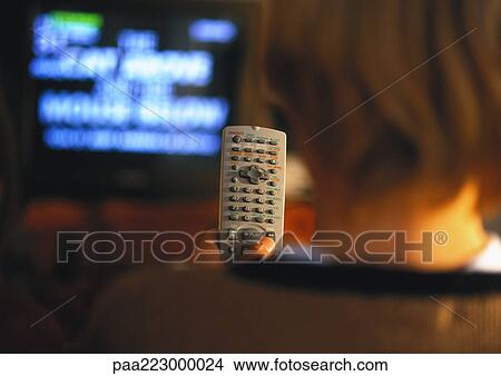 Young boy with remote in hand watching TV, rear view, close up View Large Photo Image Picture - Young boy with remote in hand watching TV, rear view, close up. Fotosearch
