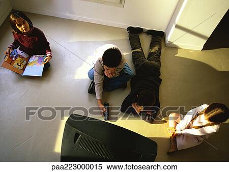 Young boys and girls sitting on floor watching TV, high angle view View Large Photo Image Stock Photography - Young boys and girls sitting on floor watching TV, high angle view. Fotosearch