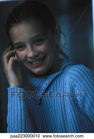 Young girl on phone smiling, close up. View Large Photo Image Stock Image - Young girl on phone smiling, close up.. Fotosearch