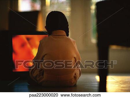 Young girl sitting on floor watching TV, rear view View Large Photo Image Stock Image - Young girl sitting on floor watching TV, rear view. Fotosearch