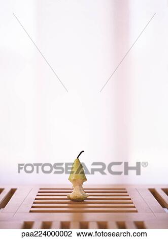 Apple core on wooden table. View Large Photo Image Stock Image - Apple core on wooden table.. Fotosearch