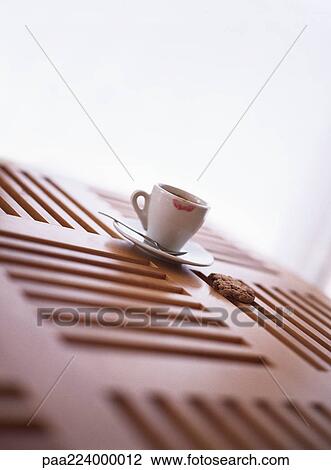Cookie and tea cup sitting on wooden table. View Large Photo Image Stock Image - Cookie and tea cup sitting on wooden table.. Fotosearch