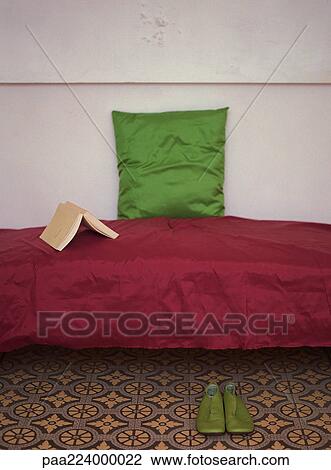 Couch with open book and pillow on top, pair of shoes nearby. View Large Photo Image Stock Image - Couch with open book and pillow on top, pair of shoes nearby.. Fotosearch