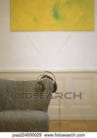 Headphones placed on back of chair, partial view. View Large Photo Image Stock Photo - Headphones placed on back of chair, partial view.. Fotosearch