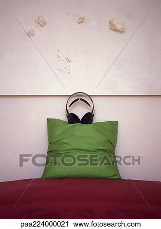 Headphones placed on top of pillow on couch. View Large Photo Image Stock Image - Headphones placed on top of pillow on couch.. Fotosearch