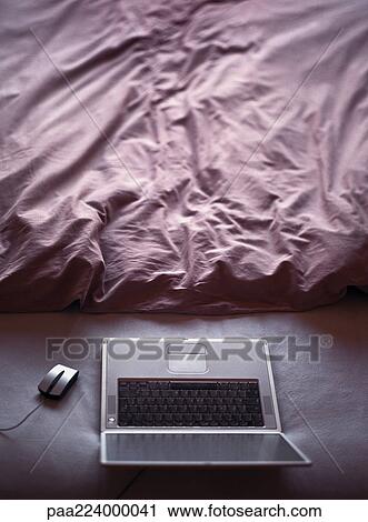Laptop on floor next to sheets. View Large Photo Image Stock Image - Laptop on floor next to sheets.. Fotosearch