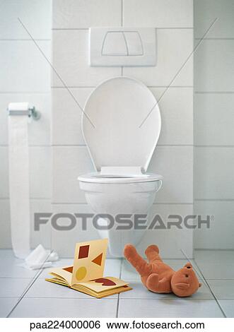 Open book and teddy bear on floor in front of toilet. View Large Photo Image Stock Photograph - Open book and teddy bear on floor in front of toilet.. Fotosearch