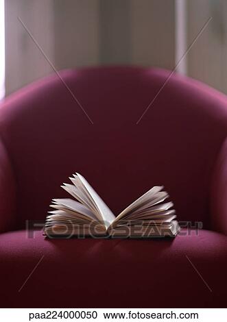 Open book on chair. View Large Photo Image Stock Image - Open book on chair.. Fotosearch