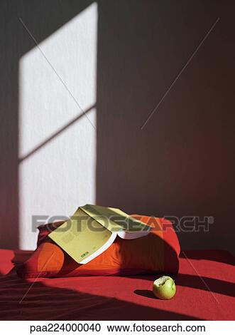 Open book on pillow next to apple. View Large Photo Image Stock Image - Open book on pillow next to apple.. Fotosearch
