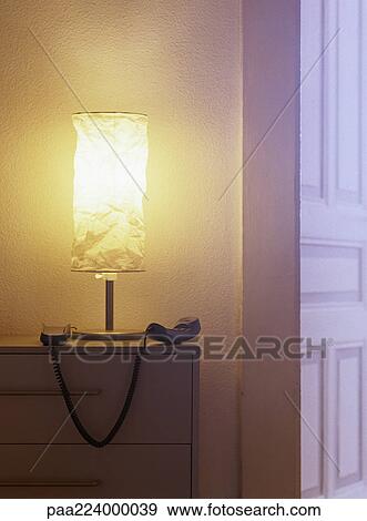 Phone off hook next to lamp on top of chest of drawers. View Large Photo Image Stock Photo - Phone off hook next to lamp on top of chest of drawers.. Fotosearch