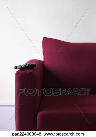 Remote control on couch arm, partial view. View Large Photo Image Stock Photo - Remote control on couch arm, partial view.. Fotosearch