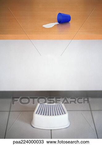 Step stool in front of counter with spilled milk and cup View Large Photo Image Stock Image - Step stool in front of counter with spilled milk and cup. Fotosearch