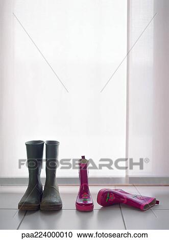 Two pairs of rubber boots, one boot resting on side. View Large Photo Image Stock Image - Two pairs of rubber boots, one boot resting on side.. Fotosearch