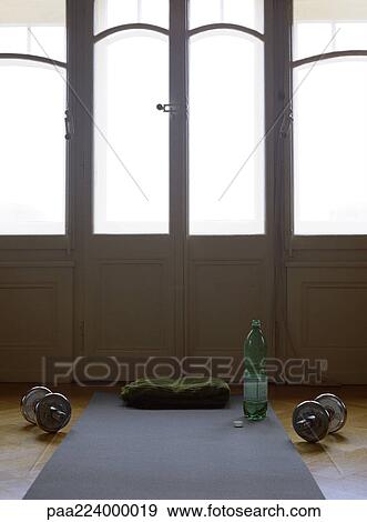 Weights on floor next to bottle and workout mat. View Large Photo Image Stock Photo - Weights on floor next to bottle and workout mat.. Fotosearch