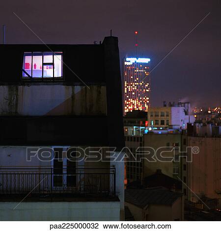 Apartment, buildings lit up at night. View Large Photo Image Stock Image - Apartment, buildings lit up at night.. Fotosearch
