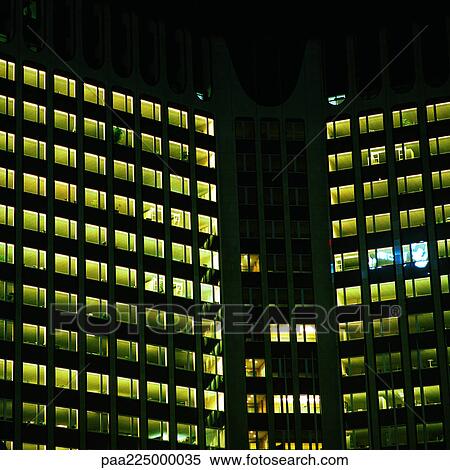 Stock Photography - Office buildings lit up at night, exterior. Fotosearch