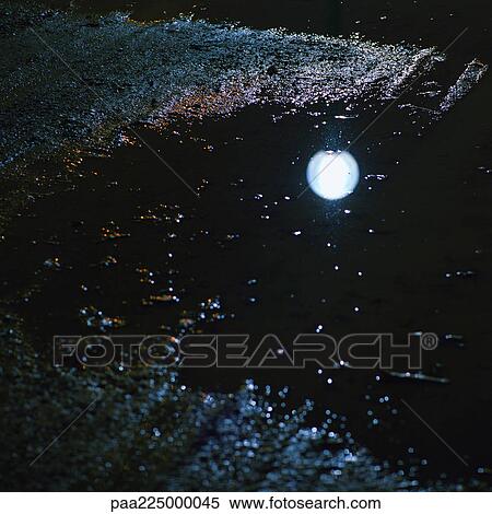 Reflection of street light in puddle, night. View Large Photo Image Stock Photography - Reflection of street light in puddle, night.. Fotosearch