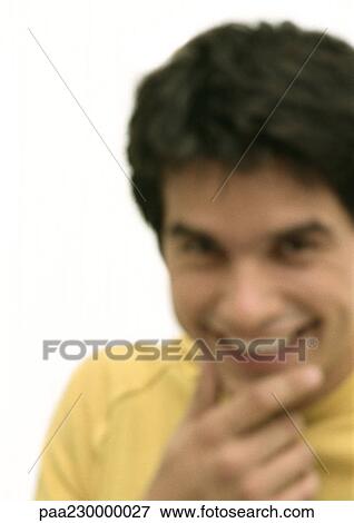 Man smiling, hand to chin, blurred portrait. View Large Photo Image Stock Photo - Man smiling, hand to chin, blurred portrait.. Fotosearch