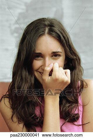 Woman covering mouth with fist, smiling, portrait. View Large Photo Image Stock Image - Woman covering mouth with fist, smiling, portrait.. Fotosearch