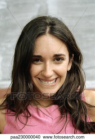 Woman smiling, biting lower lip, portrait. View Large Photo Image Stock Image - Woman smiling, biting lower lip, portrait.. Fotosearch