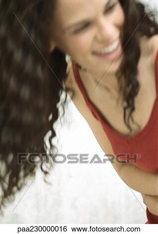 Woman smiling looking away, blurred portrait. View Large Photo Image Stock Photograph - Woman smiling looking away, blurred portrait.. Fotosearch
