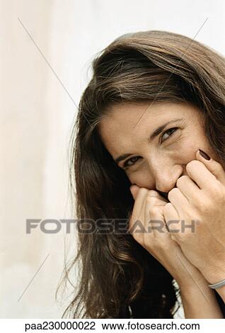 Woman with fists to mouth, portrait. View Large Photo Image Stock Image - Woman with fists to mouth, portrait.. Fotosearch